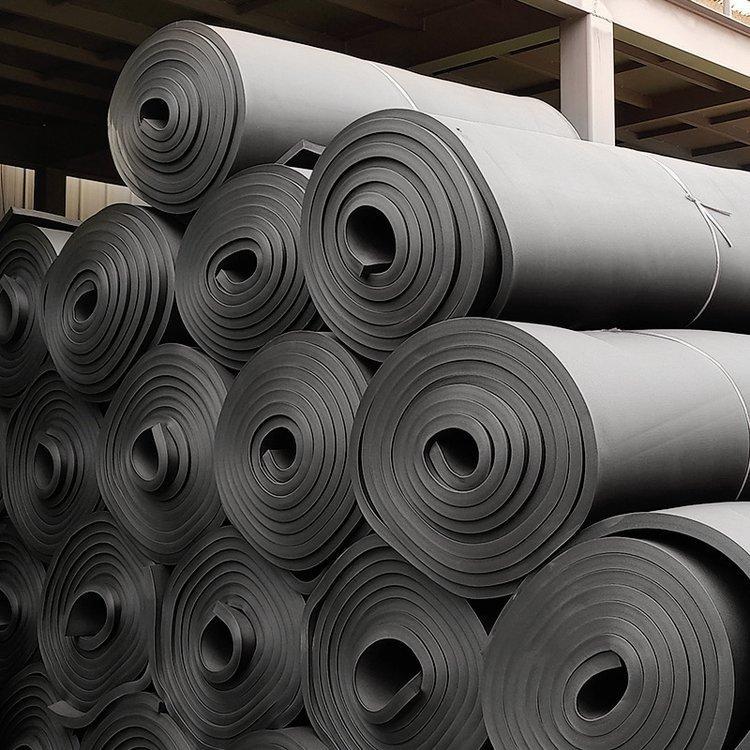 Bulk-rubber-foam-insulation-rolls-stacked-in-warehouse-for-supply