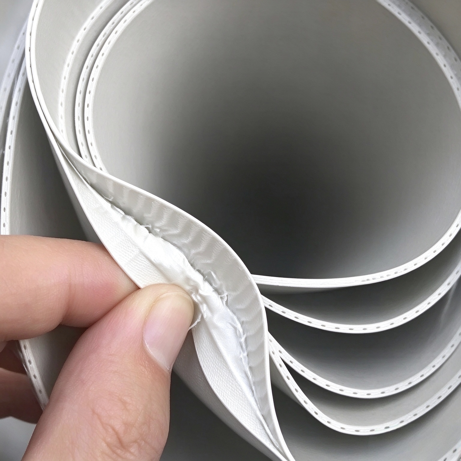 Close-up-of-reinforced-TPO-membrane-showing-internal-polyester-reinforcement